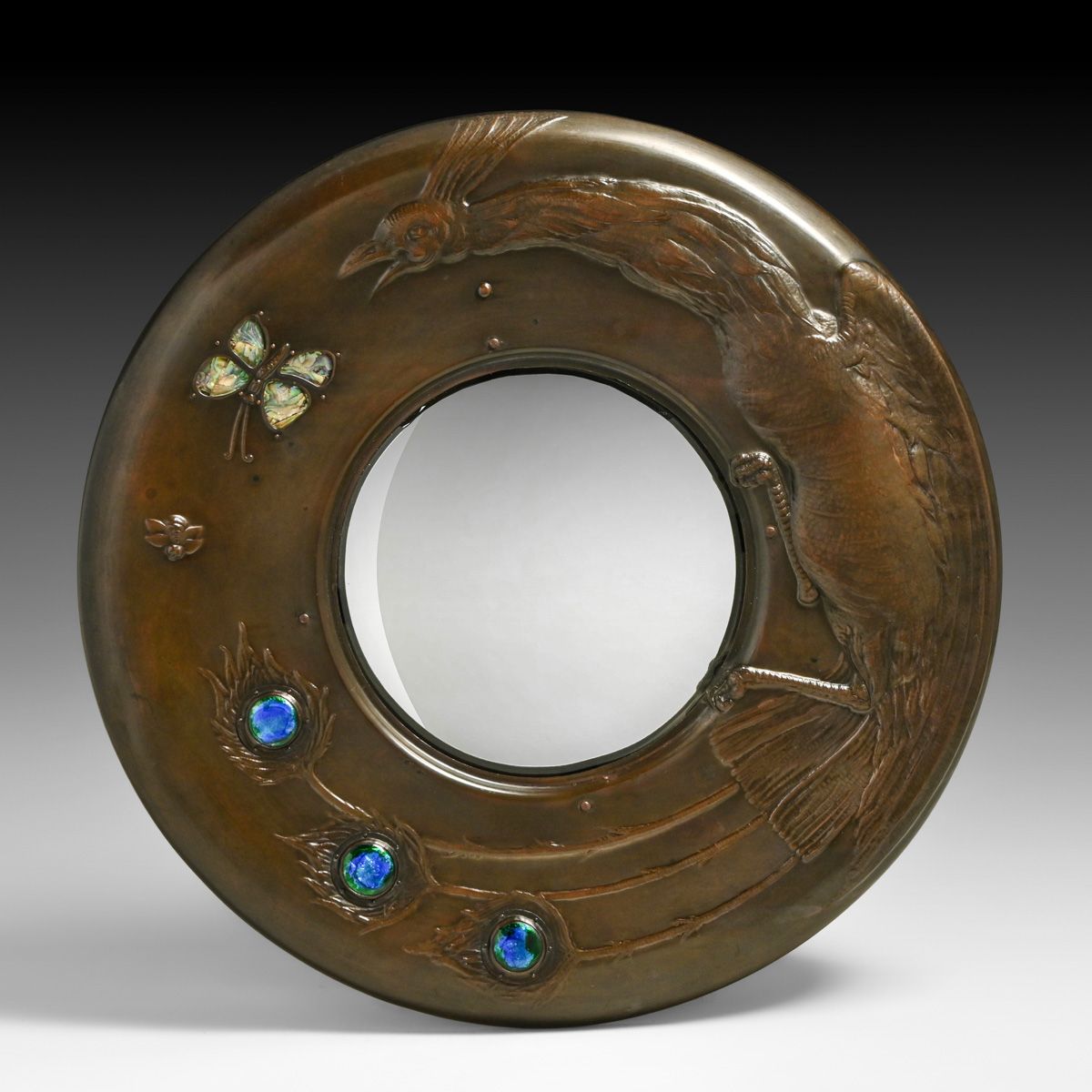 Important Guild of Handicraft Repoussé Hammered Copper & Enamel Peacock Mirror c1898-1902